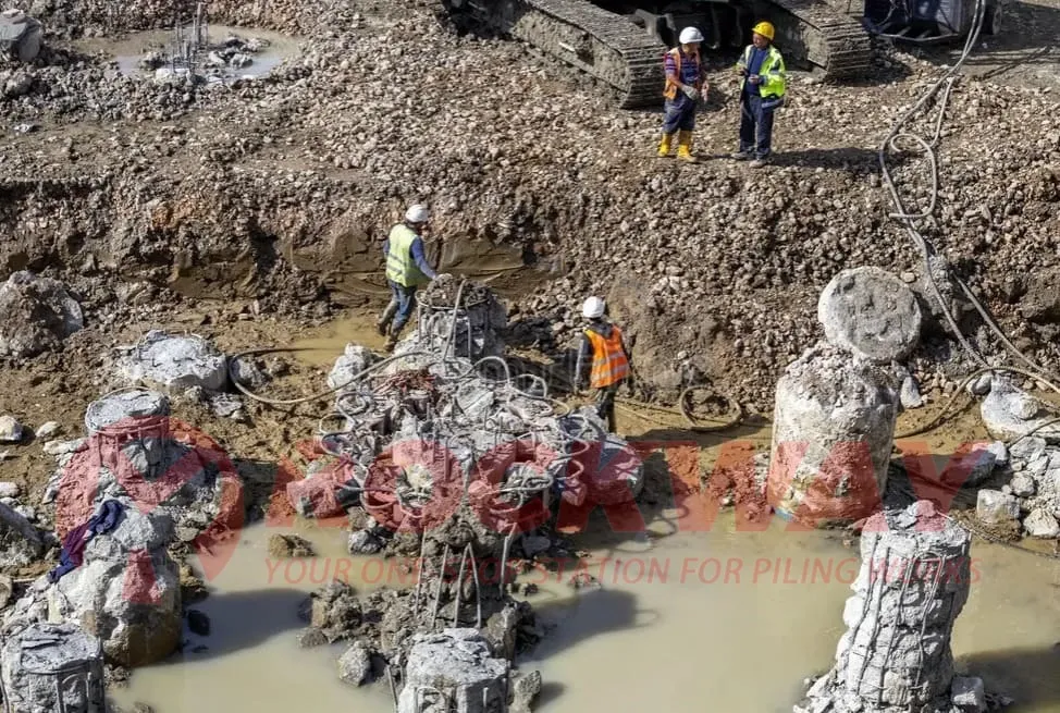 Hydraulic pile breaker breaking concrete pile heads on a bored pile foundation construction site